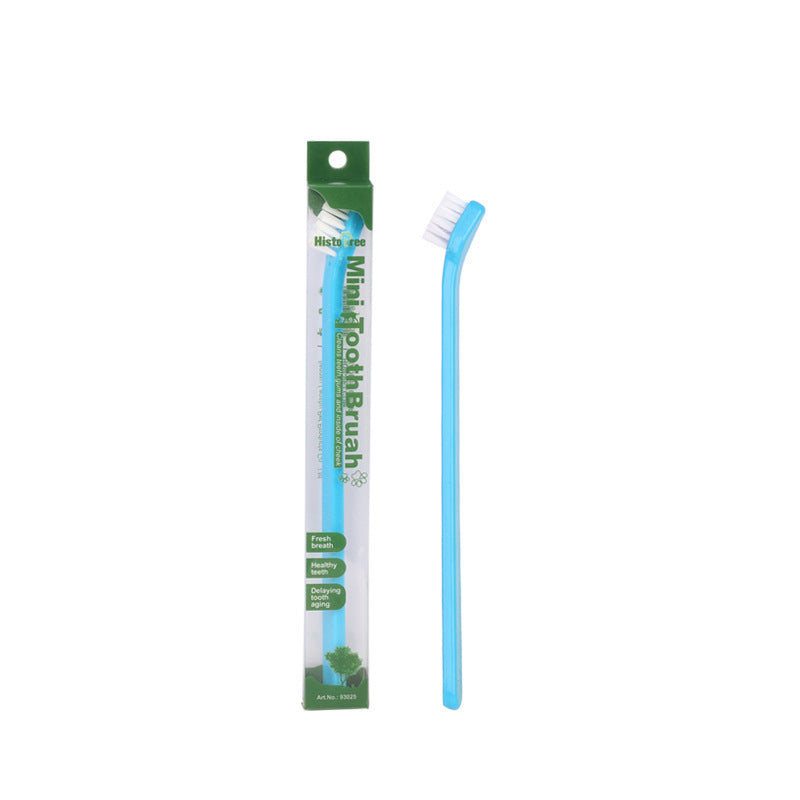 Blue mini pet toothbrush beside green and white package