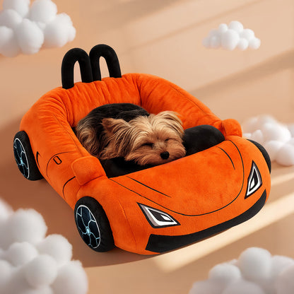 Small dog sleeping inside an orange sports car pet bed with black wheels