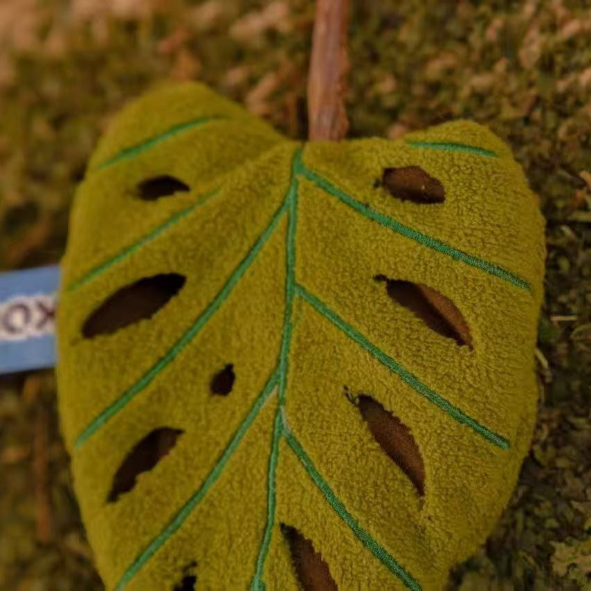 Close-up of plush leaf catnip toy with silvervine stick for chewing, kicking and interactive cat play