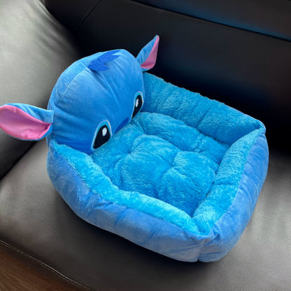 Angled view of the blue Stitch pet bed with low front entry