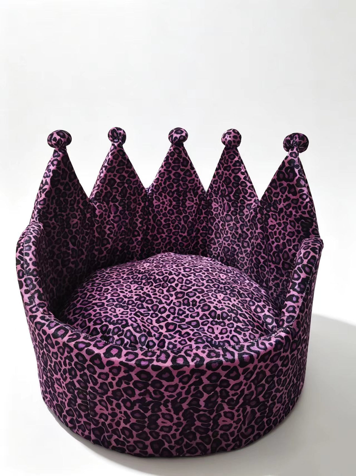 Front studio view of purple leopard crown-shaped pet bed with round cushion