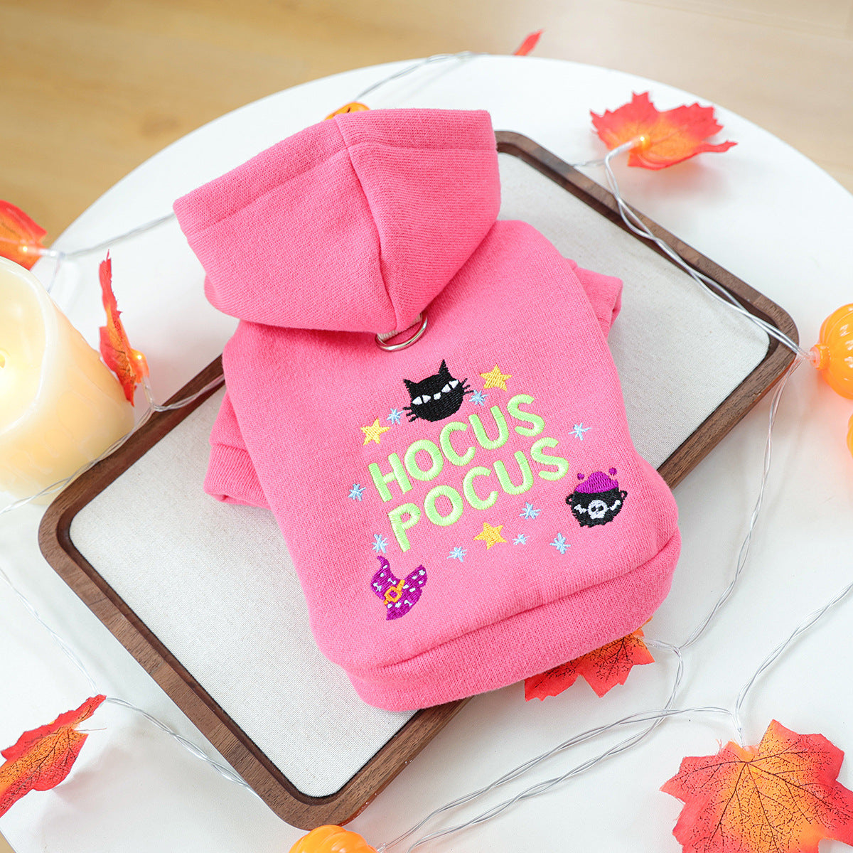 Pink Halloween pet hoodie laid flat with colorful Hocus Pocus embroidery