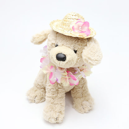 Plush dog wearing pink pastel flower lei and straw pet hat