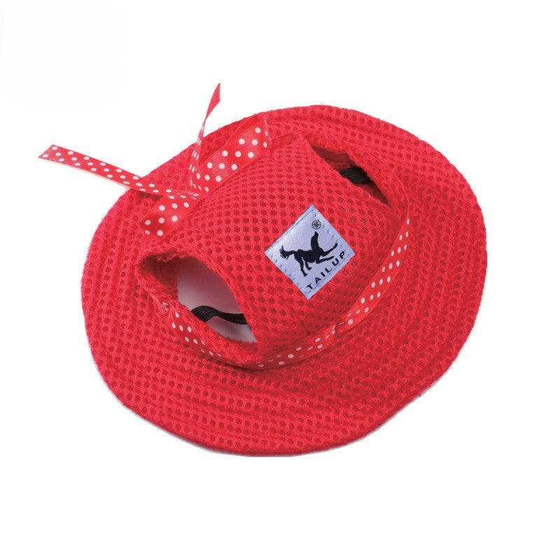 Red pet sun hat with ear holes and polka dot bow on white background