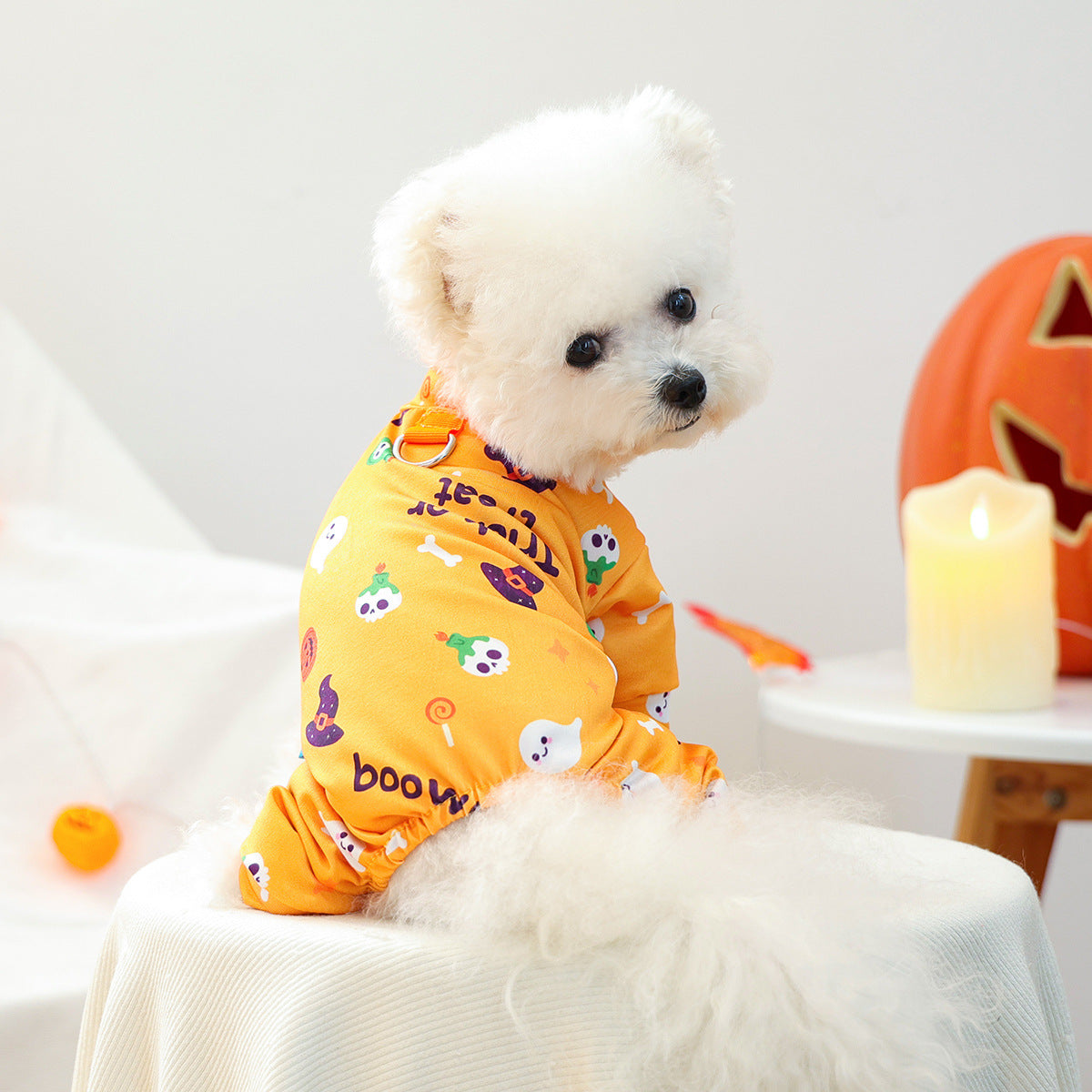 Back view of orange Halloween pet pajamas showing printed pattern and metal ring detail