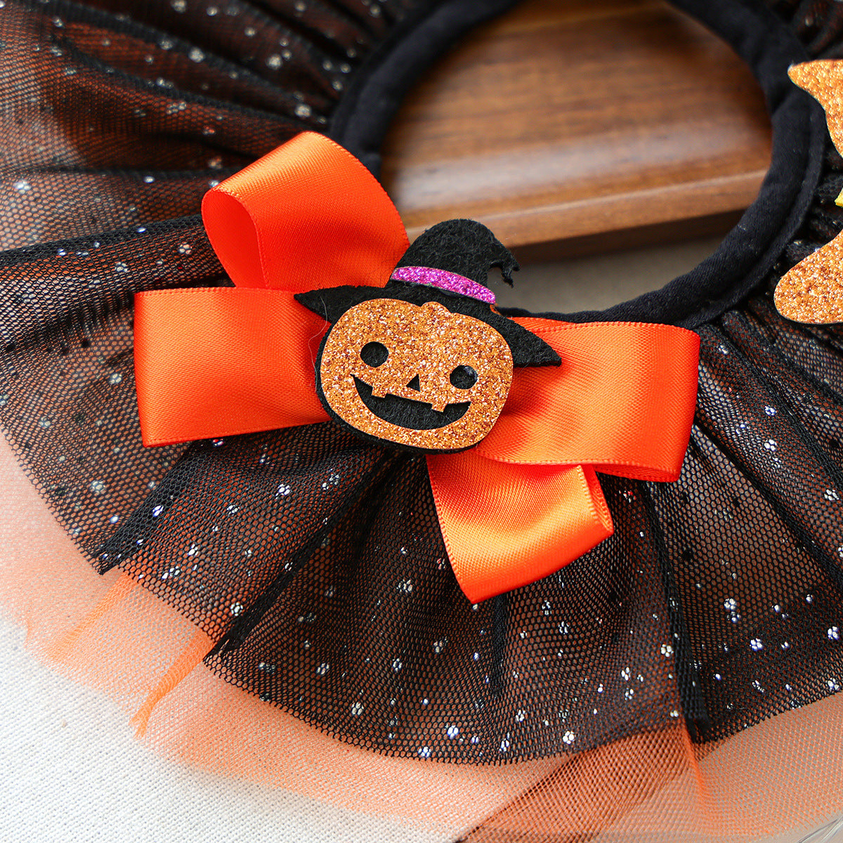 Orange satin-look bow and jack-o-lantern detail on pet ruffle collar