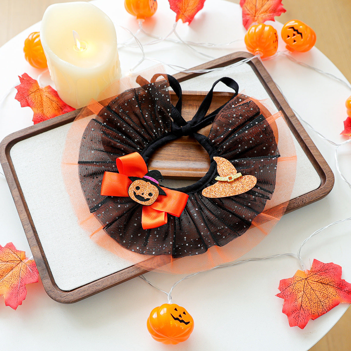 Black and orange pumpkin witch hat pet ruffle collar on tray