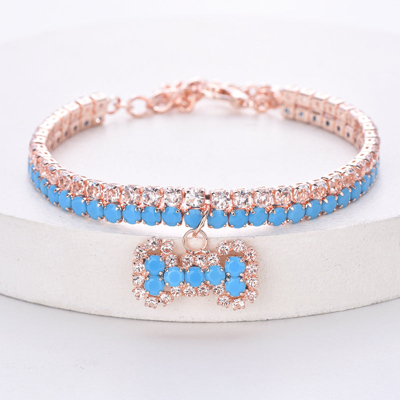 Blue rhinestone pet necklace with rose-gold-tone setting and bone charm