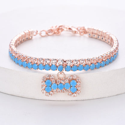 Blue rhinestone pet necklace with rose-gold-tone setting and bone charm