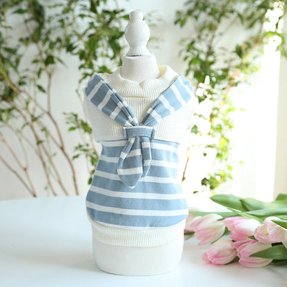 Blue striped sailor pet shirt displayed on a mannequin beside flowers
