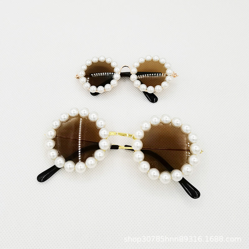 Small and large brown lens pearl round pet sunglasses on white background
