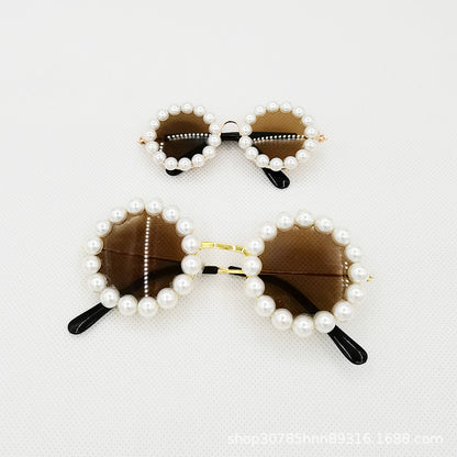 Small and large brown lens pearl round pet sunglasses on white background