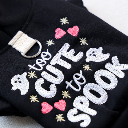 Close-up of black Halloween pet hoodie with white ghost and pink heart embroidery