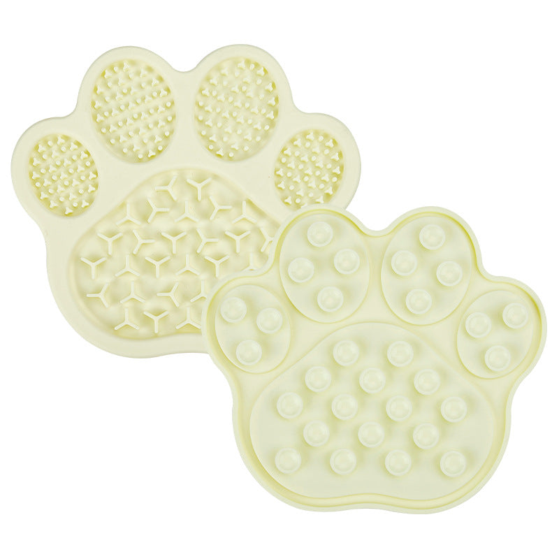 Light yellow paw silicone pet lick mat with textured front and suction cup back