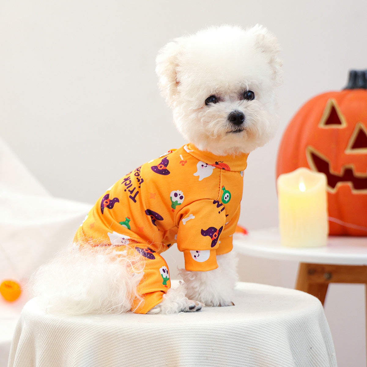 Side view of orange four-leg Halloween dog pajamas with ghost and pumpkin print
