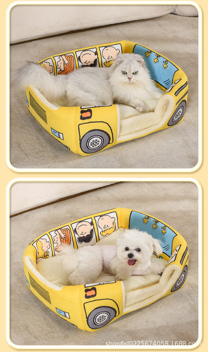 White cat and small dog resting separately in the open yellow bus pet bed