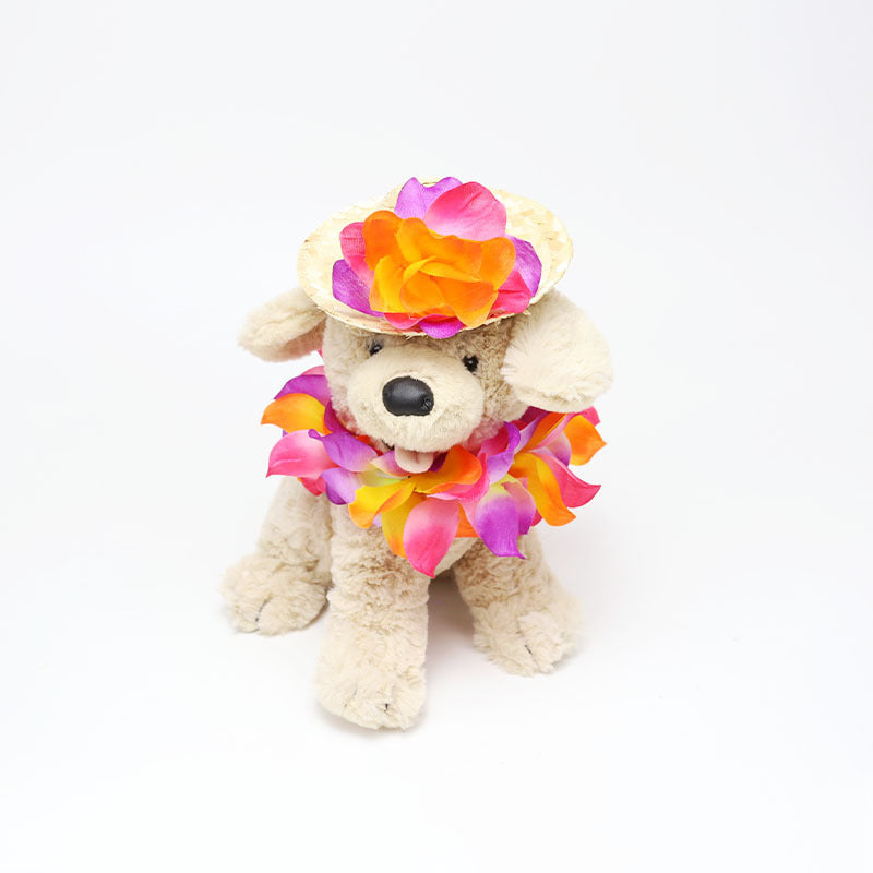 Plush dog wearing bright tropical flower lei and straw pet hat