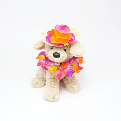 Plush dog wearing bright tropical flower lei and straw pet hat