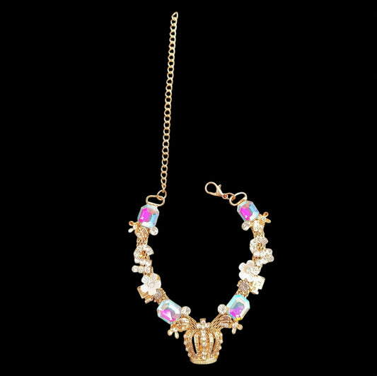 Gold crown pet necklace full view on black background with adjustable chain, clasp, flower accents, and iridescent stones