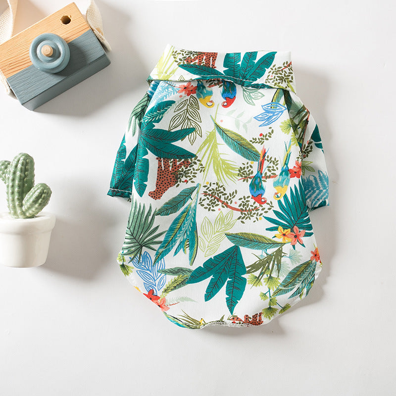 Flat lay of the green tropical Hawaiian dog shirt with leaf and bird print