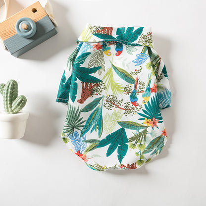 Flat lay of the green tropical Hawaiian dog shirt with leaf and bird print