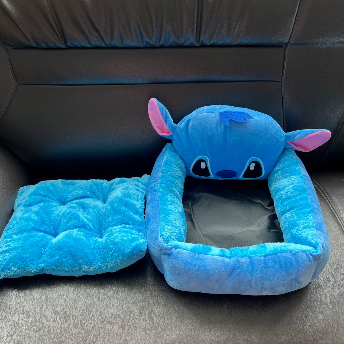Removable blue tufted cushion displayed beside the empty Stitch pet bed