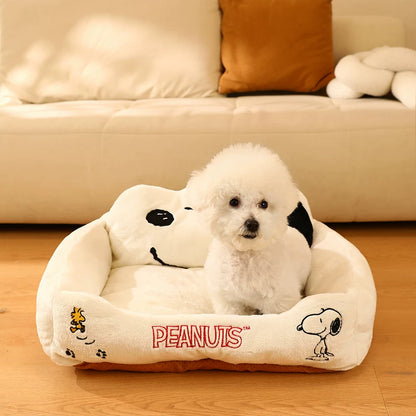 Front view of Snoopy pet couch with raised sides and embroidered characters