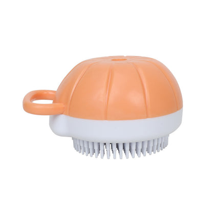 Orange and white pet shampoo dispensing bath brush with bristles and handle loop