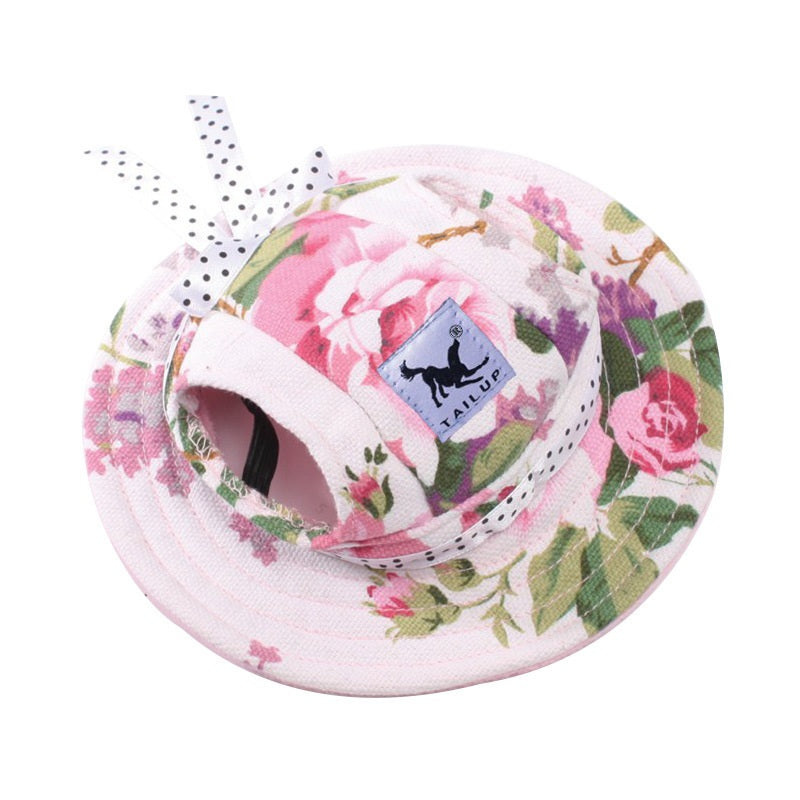 Pink floral pet sun hat with ear holes and polka dot bow on white background