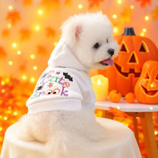 Small white dog modeling a white hooded Halloween pet sweatshirt