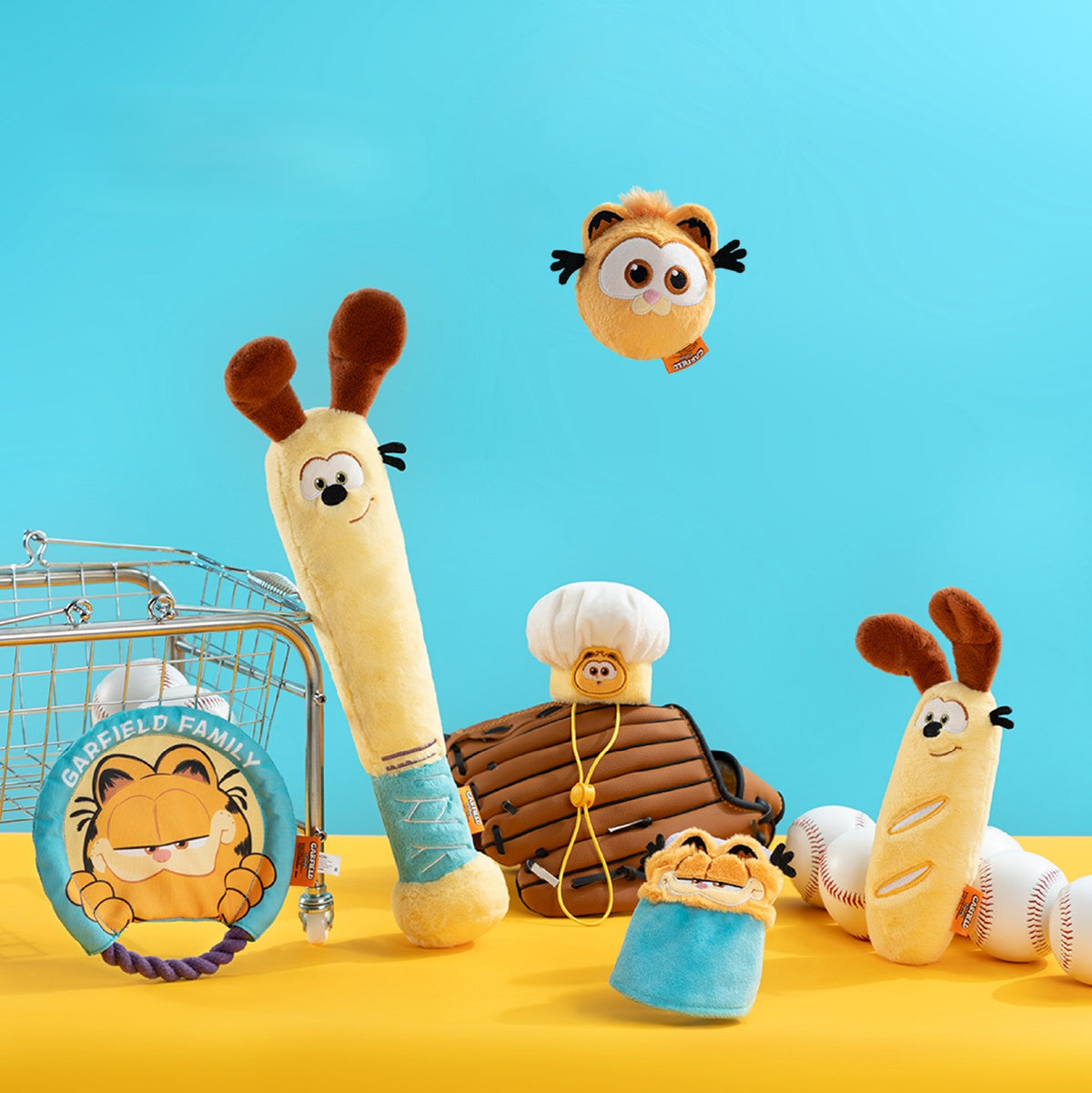 Garfield and Odie plush pet toy collection displayed with sports props