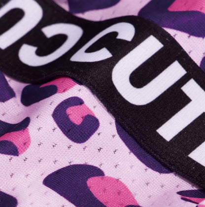 Close-up of the pink leopard print fabric and black CUTE band on the dog dress