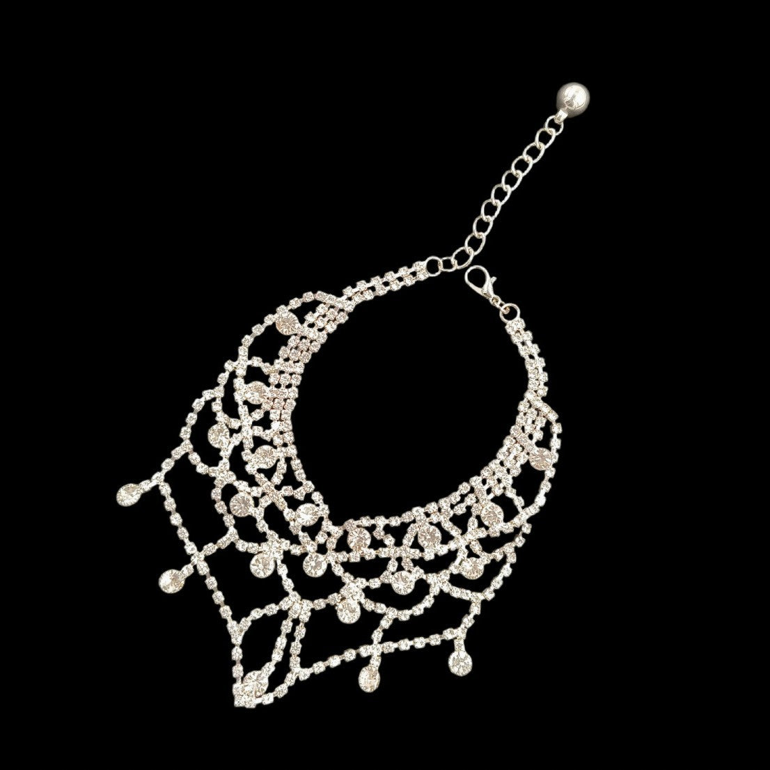 Silver pet necklace angled view with adjustable chain, clasp, scalloped front, and dangling accents