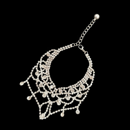 Silver pet necklace angled view with adjustable chain, clasp, scalloped front, and dangling accents