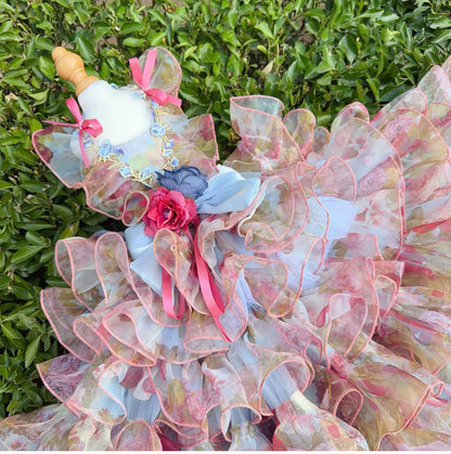 Close view of pastel floral tulle pet dress with pink ribbons and blue bow