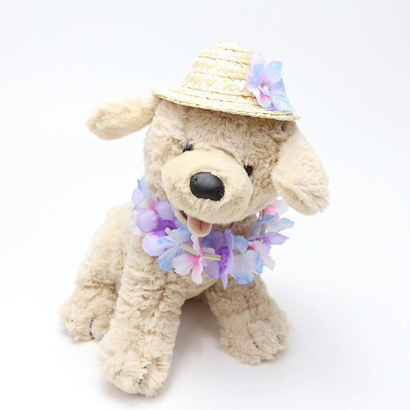 Plush dog wearing pastel flower lei and straw pet hat