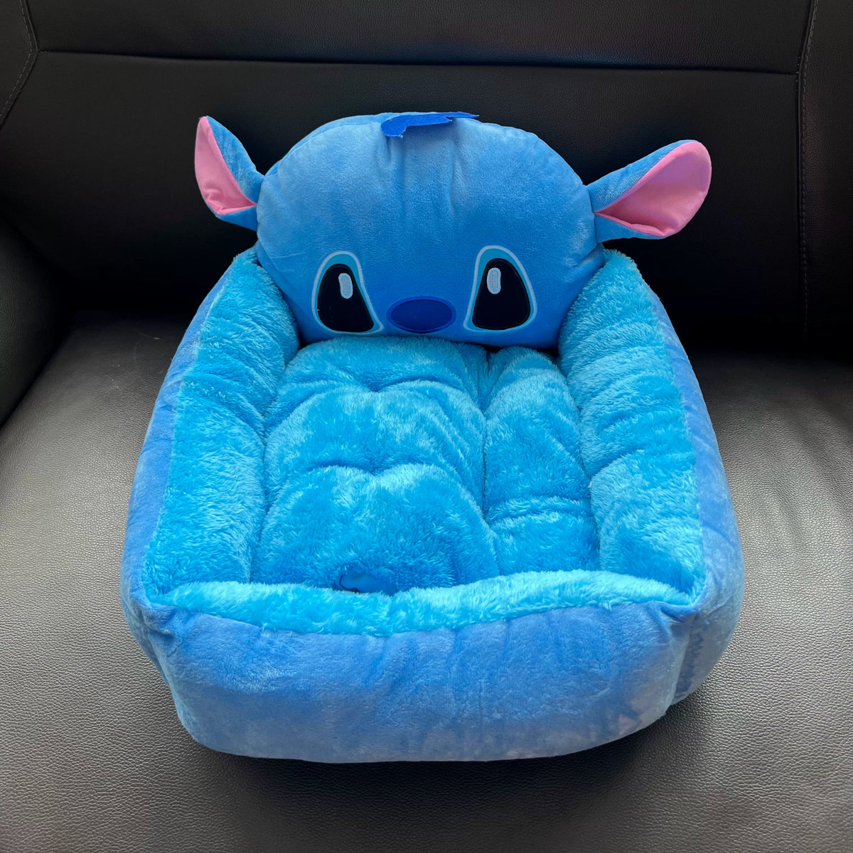 Front view of the Disney Stitch plush pet bed and tufted cushion