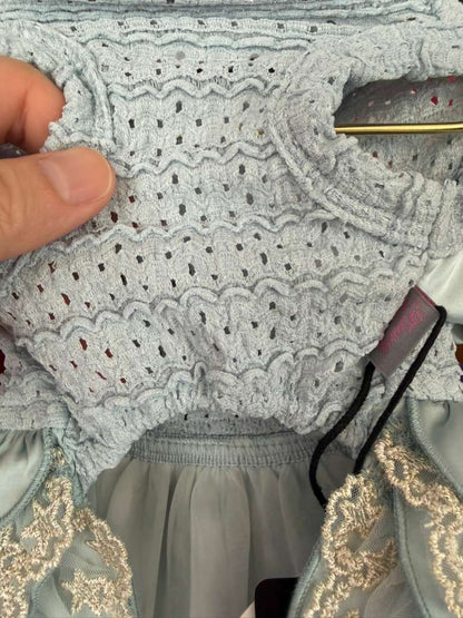 Close-up detail of breathable crochet knit dog dress fabric showing soft stretch construction