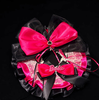 Close-up of Babi hot pink and black pet bib collar with lace ruffles