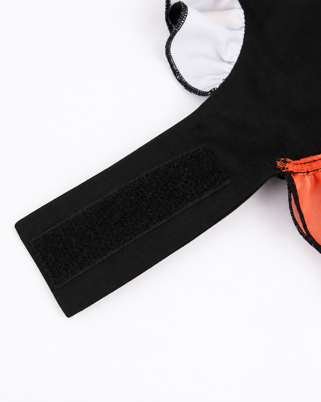 Wide hook and loop fastening tab inside black and orange Halloween pet dress