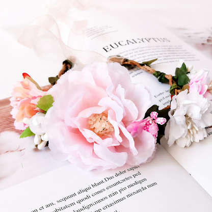 Pink and white floral pet crown headpiece close up with ribbon tie