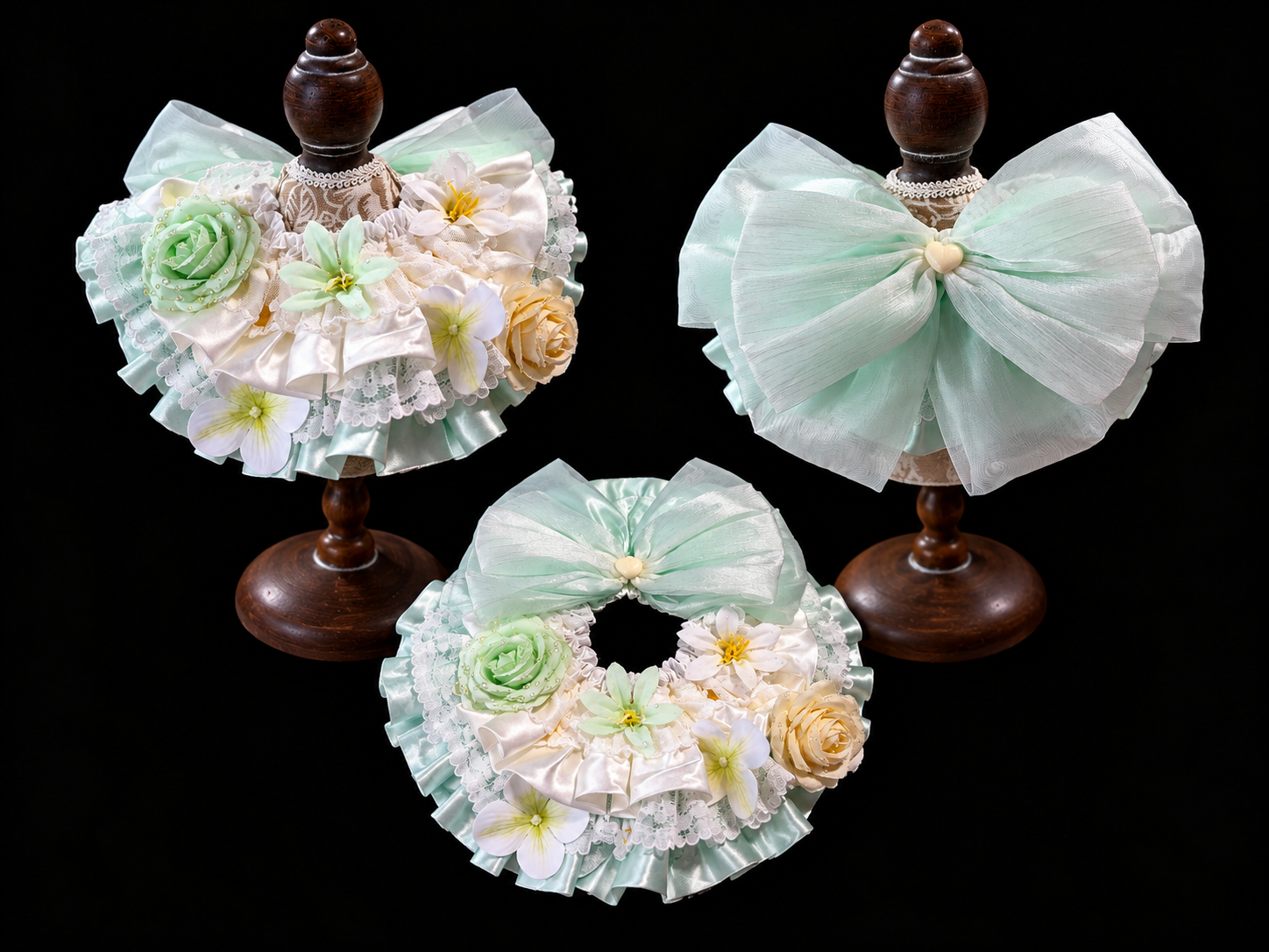 Green floral pet bib collar display showing front and back views on stands