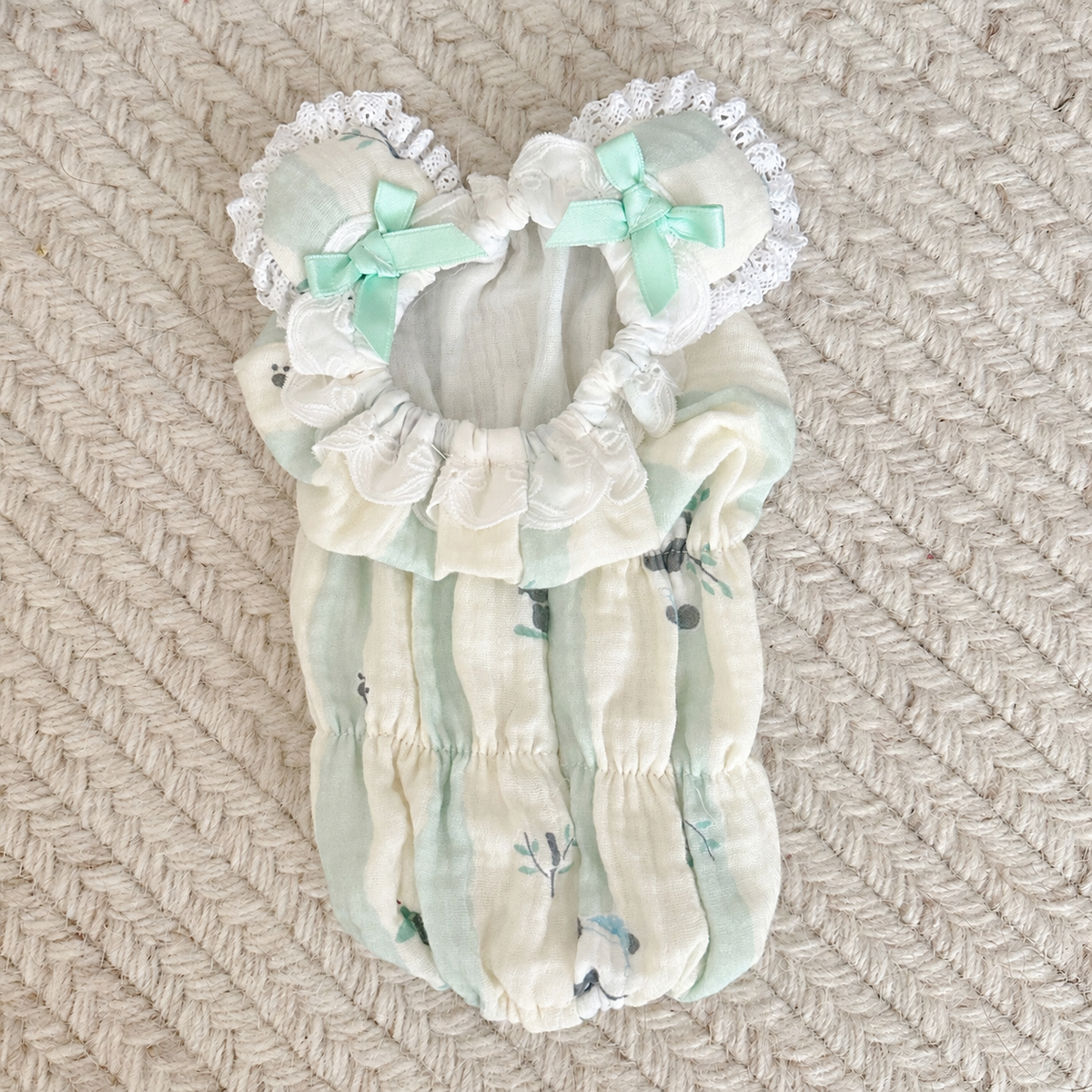 Green striped cotton dog snood shown flat with lace and bow accents
