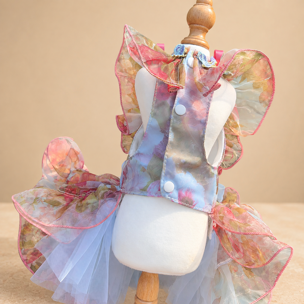 Back view of pastel floral tulle pet dress with white buttons and ruffles