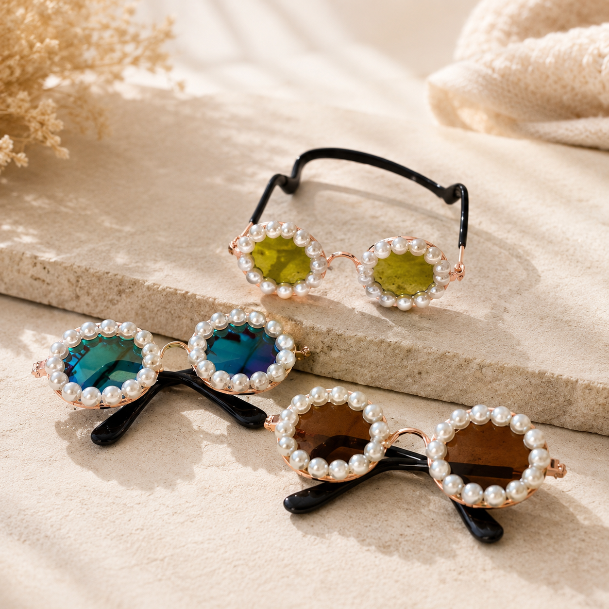 Gold, gradient, and brown pearl round pet sunglasses arranged on stone
