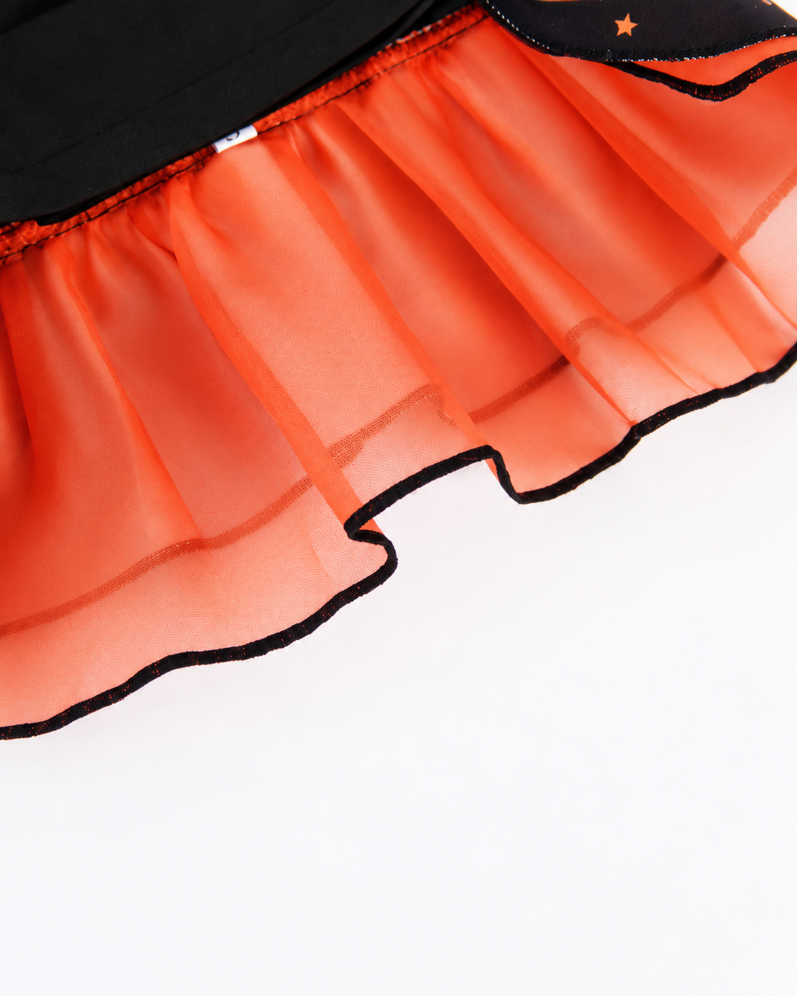 Close-up of orange tulle underskirt and black edged ruffles on Halloween pet dress