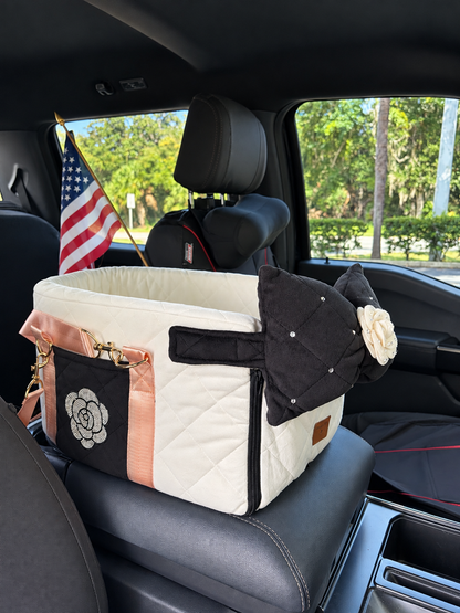 White black and pink quilted pet car carrier shown inside a vehicle