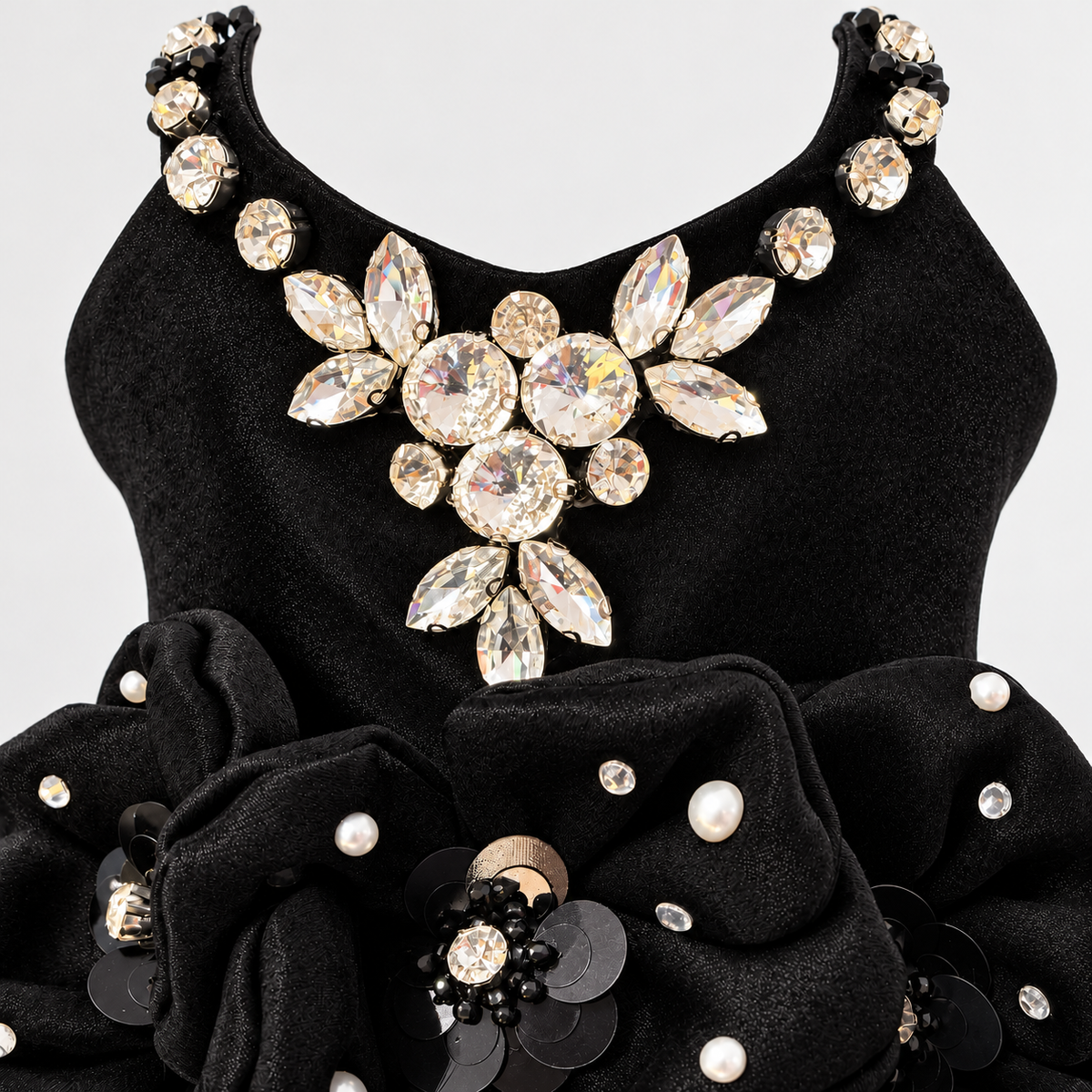 Detailed view of jeweled neckline and floral waist embellishments on black pet dress