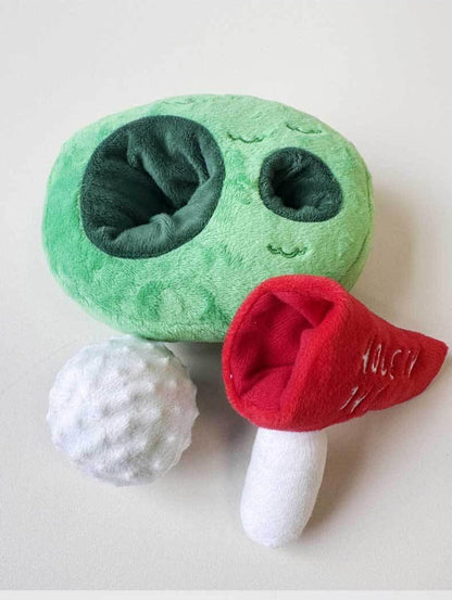 Three-piece golf course dog toy with green base white ball and red flag